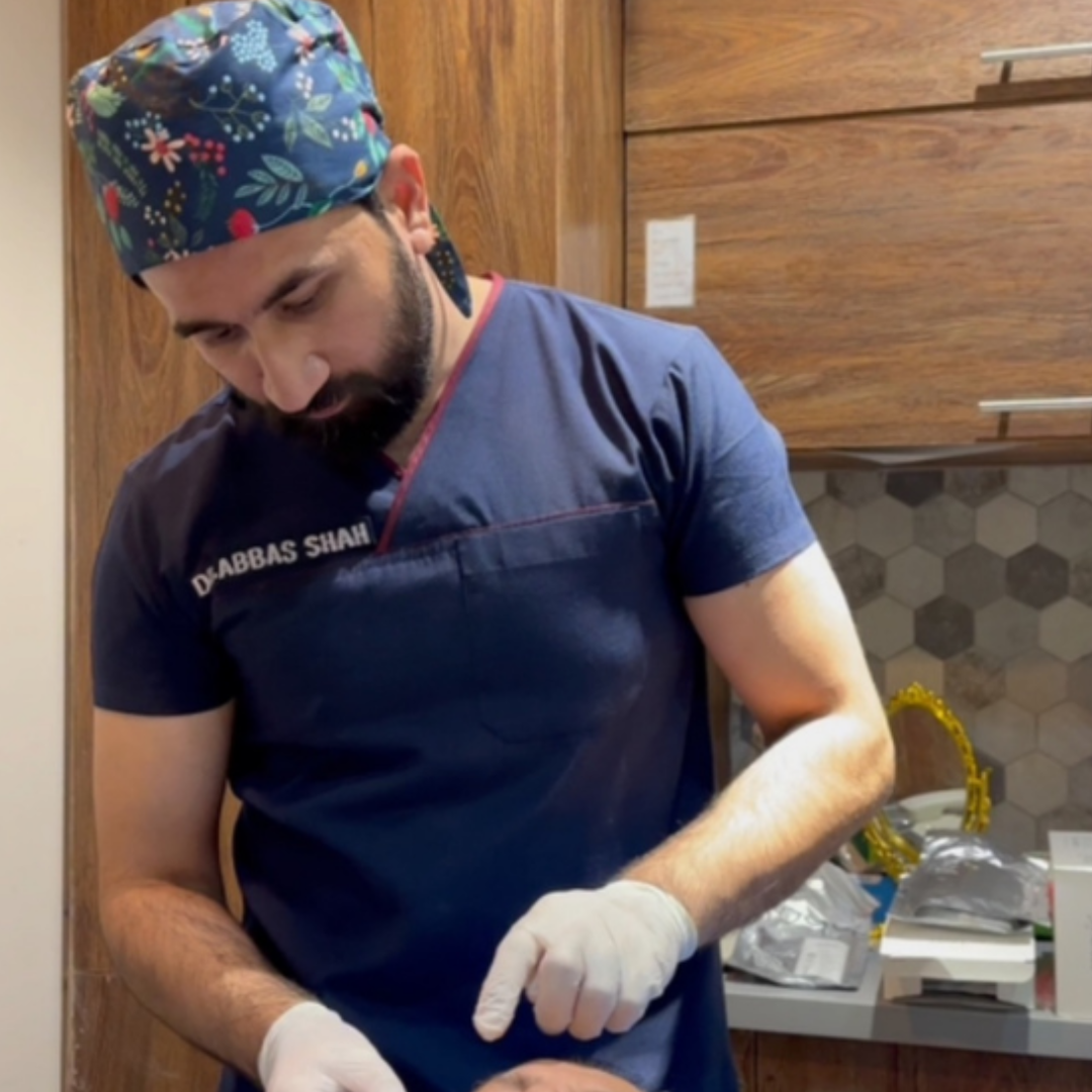 dr abbas doing facial treatment